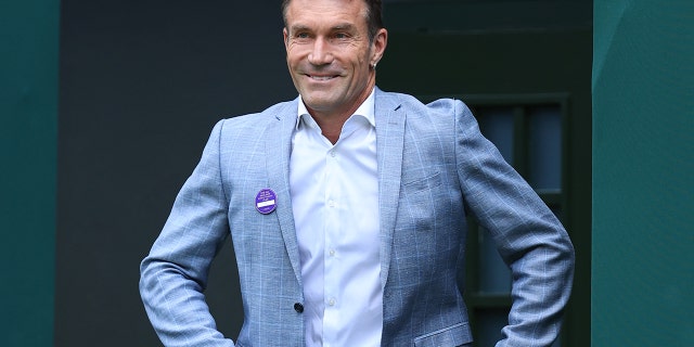 Former Wimbledon champion Pat Cash walks onto Centre Court at All England Lawn Tennis and Croquet Club on July 3, 2022, in London.