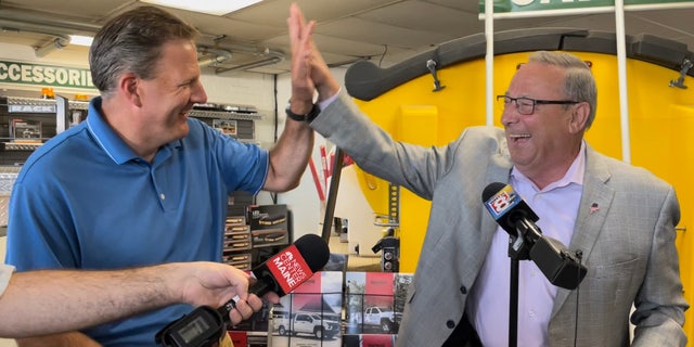 A lighter moment between Republican Gov.  Chris Sununu of New Hampshire (left) and former Maine Gov.  Paul LePage (right), the 2022 GOP gubernatorial nominee, at Messer Truck Equipment in Westbrook, Maine on July 13, 2022