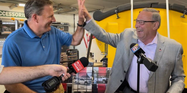 A lighter moment between Republican Gov.  Chris Sununu of New Hampshire (left) and former Maine Gov.  Paul LePage (right), the 2022 GOP gubernatorial nominee, at Messer Truck Equipment in Westbrook, Maine on July 13, 2022