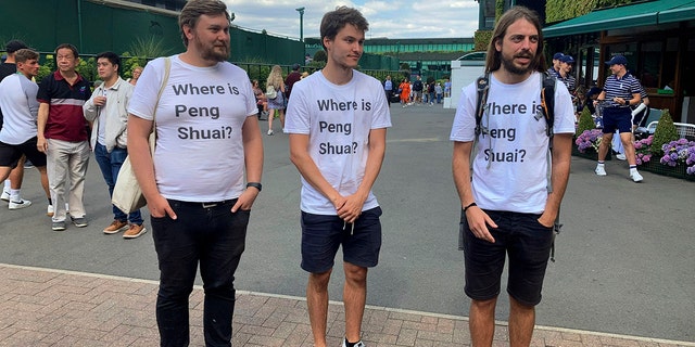 From left Protesters Will Hoyles, 39, Caleb Compton, 27, and Jason Leith, 34, who all work for Free Tibet pose for the media in T-shirts reading "Where is Peng Shuai", at the Wimbledon Tennis tournament in London, Monday, July 4, 2022.