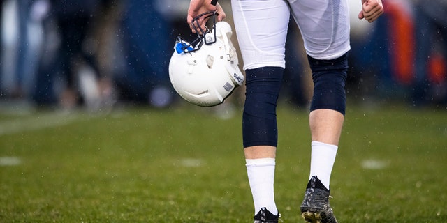 Detail view of  a player carrying a Penn State Nittany Lions football helmet in the rain before the game against the Nebraska Cornhuskers on November 18, 2017 at Beaver Stadium in University Park, Pennsylvania.