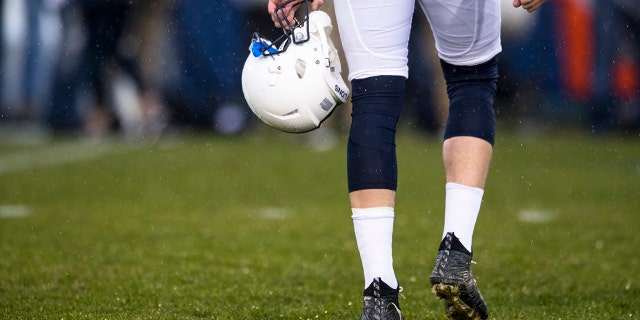 Detail view of a player carrying a Penn State Nittany Lions football helmet in the rain before the game against the Nebraska Cornhuskers on November 18, 2017 at Beaver Stadium in University Park, Pennsylvania.