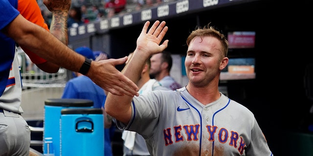 New York Mets' Pete Alonso celebrates after scoring on a Luis Guillorme ground ball against the Braves, July 11, 2022, in Atlanta.