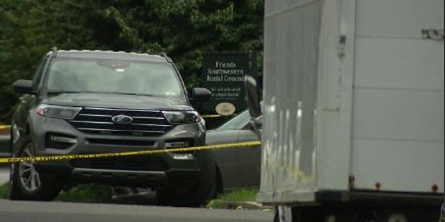 Authorities rope off the scene where two men were killed during a funeral procession near Philadelphia on Friday. 