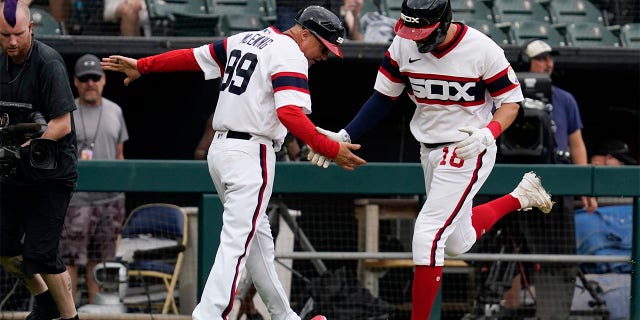 AJ Pollock of the Chicago White Sox celebrates with third base coach Joe McEwing after hitting a three-run home run during the second inning of a baseball game against the Cleveland Guardians on Sunday, July 24, 2022 in Chicago. 