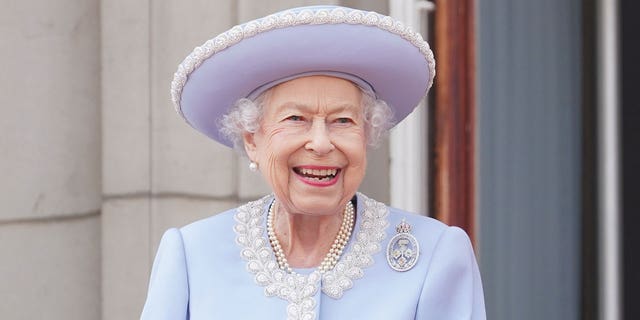 Queen Elizabeth II watches from the balcony of Buckingham Palace during the Trooping the Colour parade June 2, 2022, in London.