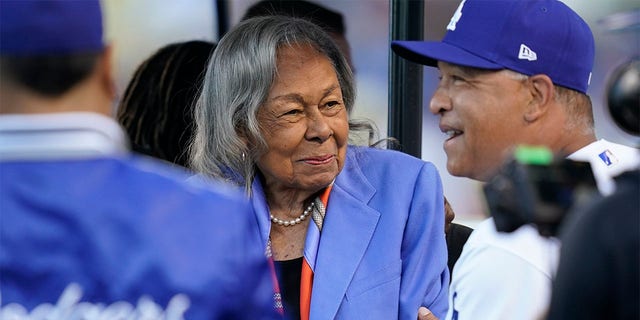 Los Angeles Dodgers' manager Dave Roberts, right, greets Rachel Robinson, wife of Jackie Robinson, before a baseball game between the Cincinnati Reds and the Los Angeles Dodgers in Los Angeles, Friday, April 15, 2022. Baseball's All-Stars gathered on the field before Tuesday night's, July 19, 2022,  game at Dodger Stadium to honor Rachel Robinson on her 100th birthday. 