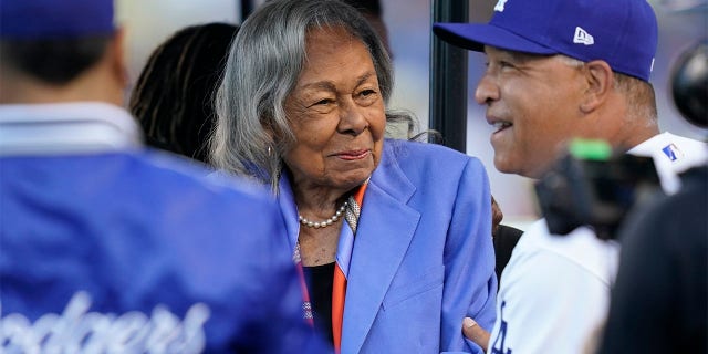 Los Angeles Dodgers' manager Dave Roberts, right, greets Rachel Robinson, wife of Jackie Robinson, before a baseball game between the Cincinnati Reds and the Los Angeles Dodgers in Los Angeles, Friday, April 15, 2022. Baseball's All-Stars gathered on the field before Tuesday night's, July 19, 2022, game at Dodger Stadium to honor Rachel Robinson on her 100th birthday.