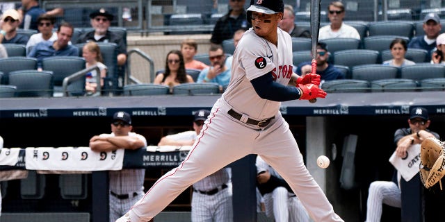 Boston Red Sox's Rafael Devers avoids a pitch during the first inning of a baseball game against the New York Yankees, Sunday, July 17, 2022, in New York.
