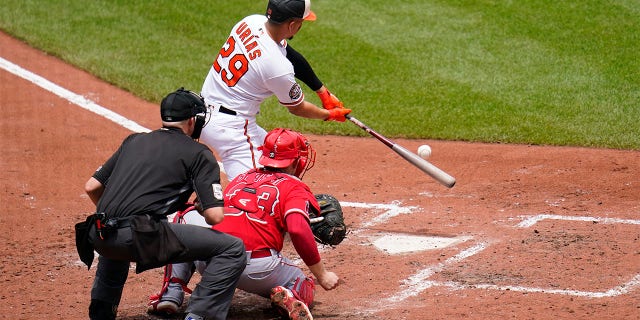 Baltimore Orioles' Ramon Urias (29) connects for a two-run single that drove in Ryan Mountcastle and Anthony Santander during the fourth inning of a baseball game against the Los Angeles Angels, Sunday, July 10, 2022, in Baltimore.
