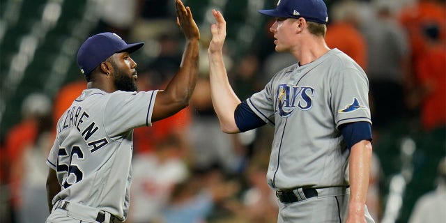 Tampa Bay Rays left fielder Randy Arozarena, left, and relief pitcher Pete Fairbanks celebrate after defeating the Baltimore Orioles 6-4 in ten innings of a baseball game, Wednesday, July 27, 2022, in Baltimore.