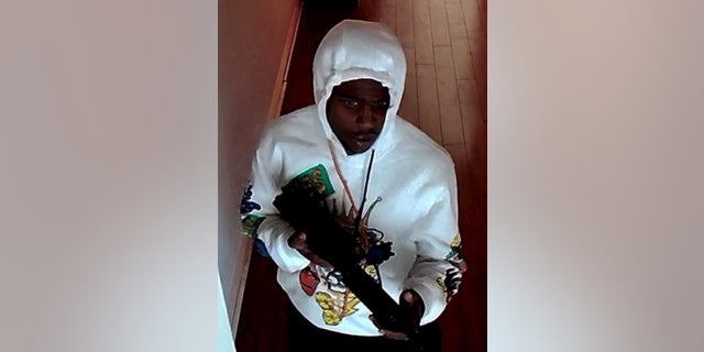 A robbery suspect being sought is seen carrying a rifle during a July 3 theft inside a Redondo Beach, California business, police said.