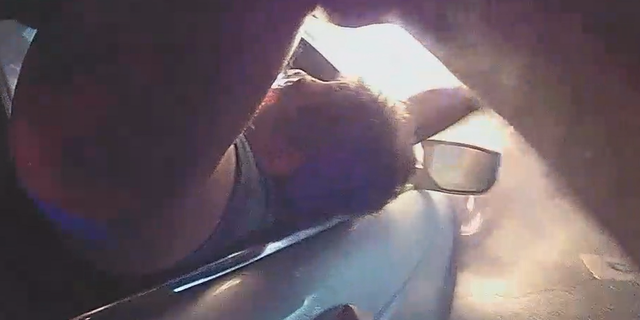 New Jersey police officers save man from burning car in dramatic video 3 The officers are seen pulling the man out of the vehicle.