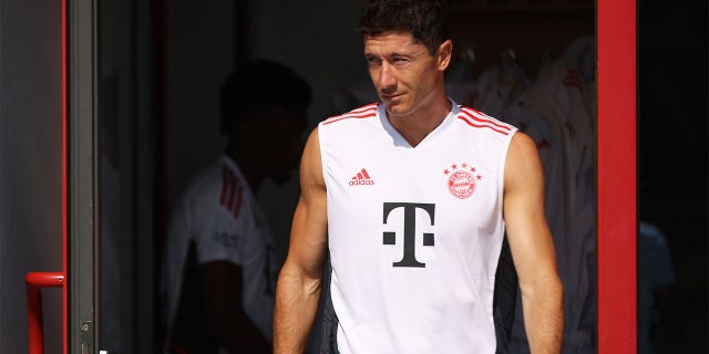 Robert Lewandowski of FC Bayern München walks onto the training pitch before a training session of FC Bayern München at Saebener Strasse training ground on July 15, 2022 in Munich, Germany.