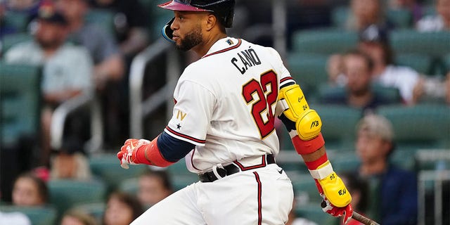 Newly acquired Atlanta Braves' Robinson Cano follows through on a single in the third inning of a baseball game against the New York Mets, Monday, July 11, 2022, in Atlanta