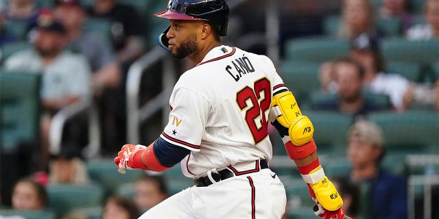 Newly acquired Atlanta Braves' Robinson Cano follows through on a single in the third inning of a baseball game against the New York Mets, Monday, July 11, 2022, in Atlanta