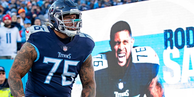 Rodger Saffold III of the Tennessee Titans runs onto the field during introductions before a game against the Cincinnati Bengals in an AFC divisional playoff game at Nissan Stadium Jan. 22, 2022, in Nashville.