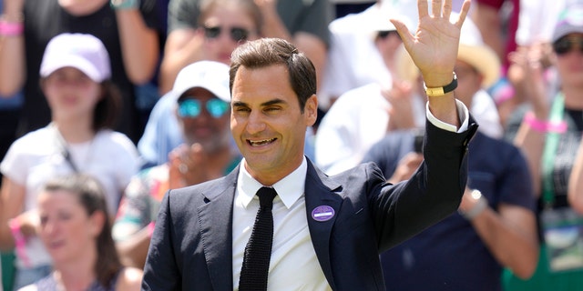 Switzerland's Roger Federer waves during celebrations to mark the centenary of Center Court on day seven of the Wimbledon tennis championships in London, Sunday July 3, 2022. 