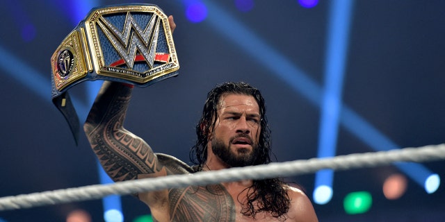 Roman Reigns celebrates after defeating Bill Goldberg during the WWE Elimination Chamber at the Jeddah Super Dome in Saudi Arabia's Red Sea coastal city of Jeddah on Feb. 19, 2022.