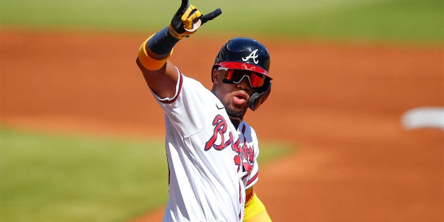 Ronald Acuna Jr. #13 of the Atlanta Braves reacts after hitting a lead-off home run in the first inning of an MLB game against the Pittsburgh Pirates at Truist Park on May 22, 2021 in Atlanta, Georgia.