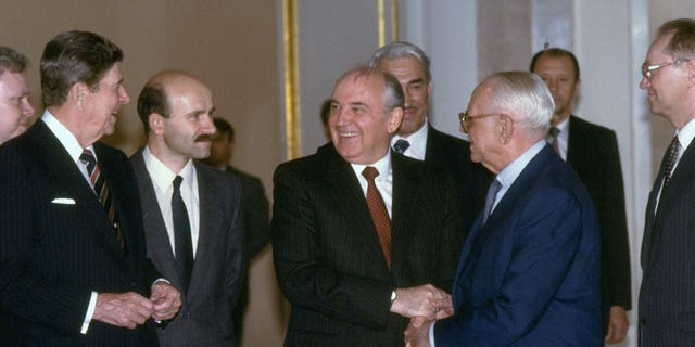 President Reagan, Soviet leader Gorbachev and Armand Hammer meet at a Grand Kremlin Palace summit fete.