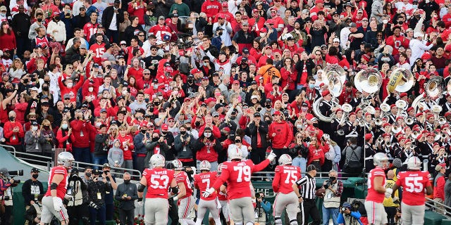 Fans in the Ohio State Buckeyes section of the Rose Bowl react to a Buckeye touchdown scored in front of them during the first half of the Rose Bowl game against the Utah Utes played on January 1, 2022 at the Rose Bowl in Pasadena CA.