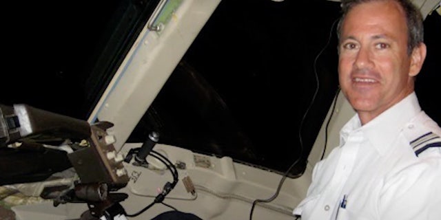 Murdered American Airlines pilot Russell Walker in the cockpit of a plane.