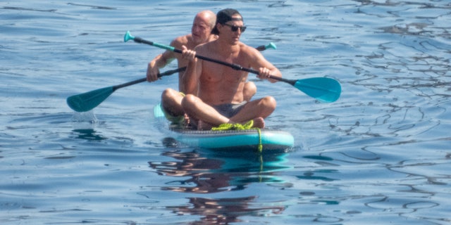 McConaughey, 52, wore a pair of grey swim trunks, and sat in the front of the soft-top board.