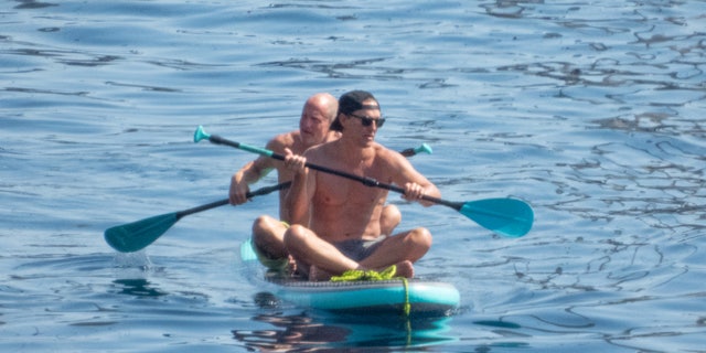 McConaughey, 52, wore a pair of grey swim trunks, and sat in the front of the soft-top board.