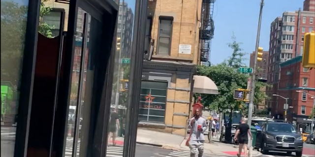 Screengrab from video of a man crossing an intersection.