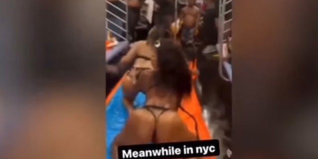 A screenshot of video posted to Twitter of a raunchy impromptu pool party on a NYC subway car.