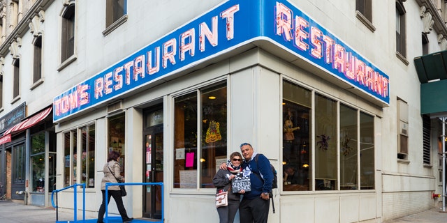 "Seinfeld" fans are shown posing in front of Tom's Restaurant.
