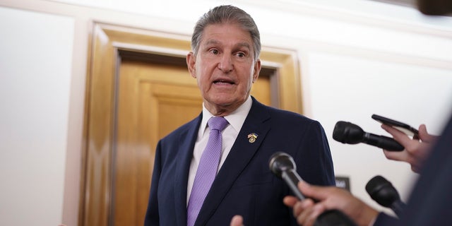 FILE - Sen. Joe Manchin, D-W.Va., is met by reporters outside the hearing room where he chairs the Senate Committee on Energy and Natural Resources, at the Capitol in Washington, July 21, 2022. 