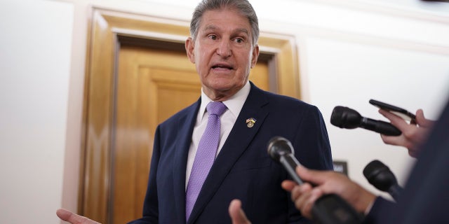 Sen. Joe Manchin, D-W.Va., is met by reporters outside the hearing room where he chairs the Senate Committee on Energy and Natural Resources, at the Capitol in Washington, July 21, 2022. 