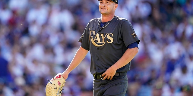 American League starting pitcher Shane McClanahan of Tampa Bay Rays smiles back in the dugout during the first inning of an MLB All-Star baseball game against the American League on Tuesday, July 19, 2022 in Los Angeles. ..