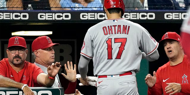 Los Angeles Angels' Shohei Ohtani (17) is greeted as he walks to the dugout after scoring on a double by Luis Rengifo during the seventh inning of a baseball game against the Kansas City Royals Tuesday, July 26, 2022, in Kansas City, Mo.