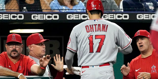 Los Angeles Angels' Shohei Ohtani (17) is greeted as he walks to the dugout after scoring on a double by Luis Rengifo during the seventh inning of a baseball game against the Kansas City Royals Tuesday, July 26, 2022, in Kansas City, Mo.