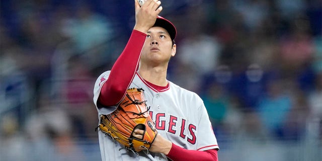 Los Angeles Angels starting pitcher Shohei Ohtani prepares to throw during the first inning of the team's baseball game against the Miami Marlins, Wednesday, July 6, 2022, in Miami. 