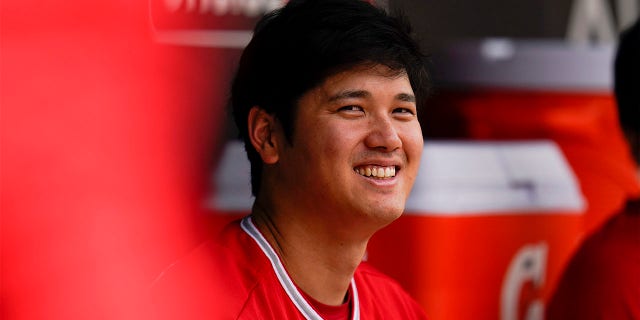 Los Angeles Angels designated hitter Shohei Ohtani sits in the dugout during the fourth inning of a baseball game against the Baltimore Orioles, Sunday, July 10, 2022, in Baltimore.