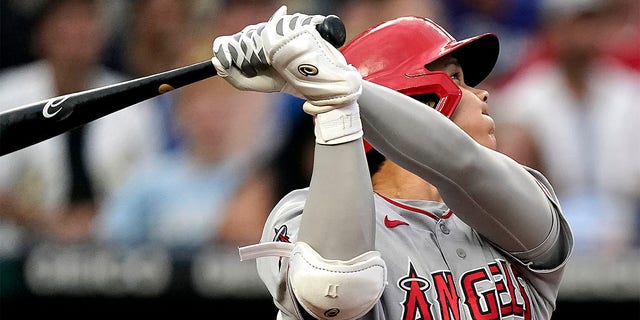 Los Angeles Angels' Shohei Ohtani watches his solo home run during the third inning of a baseball game against the Kansas City Royals Tuesday, July 26, 2022, in Kansas City, Mo. 