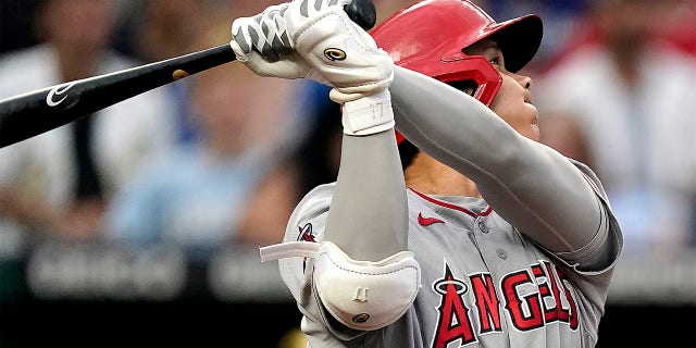 Los Angeles Angels' Shohei Ohtani watches his solo home run during the third inning of a baseball game against the Kansas City Royals Tuesday, July 26, 2022, in Kansas City, Mo. 