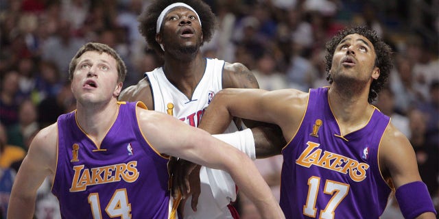 Ben Wallace #3 of the Detroit Pistons fought for the position with Slava Medvedenko #14 and Rick Fox #17 of the Los Angeles Lakers in the third quarter of game four of the 2004 NBA Finals on June 13, 2004 at the Palace of Auburn Hills.  Auburn Hills, Michigan. 