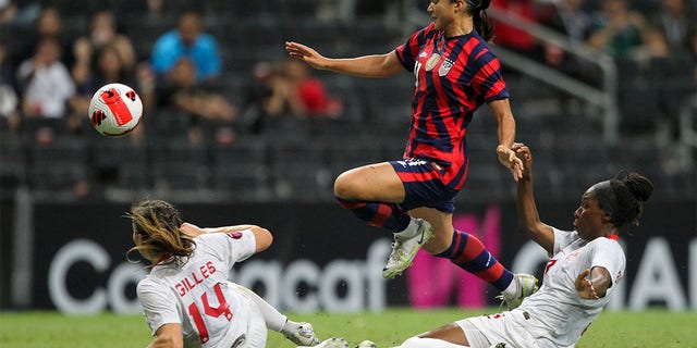 Canada's Vanessa Gilles (14) and Kadeisha Buchanan, right, challenge United States' Sophia Smithduring the CONCACAF Women's Championship final soccer match in Monterrey, Mexico, Monday, July 18, 2022. 