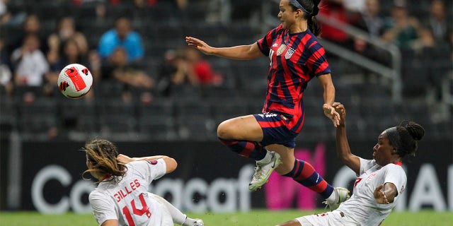 Canada's Vanessa Gilles (14) and Kadeisha Buchanan, right, challenge United States' Sophia Smithduring the CONCACAF Women's Championship final soccer match in Monterrey, Mexico, Monday, July 18, 2022.