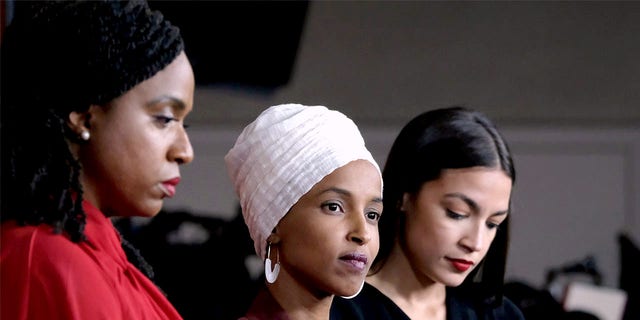 Reps. Ayanna Pressley, D-Mass., Ilhan Omar, D-Minn., and Alexandria Ocasio-Cortez, D-N.Y., listen during a news conference at the U.S. Capitol on July 15, 2019, in Washington, D.C. 