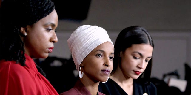 Reps. Ayanna Pressley, D-Mass., Ilhan Omar, D-Minn., and Alexandria Ocasio-Cortez, D-N.Y., listen during a news conference at the U.S. Capitol on July 15, 2019, in Washington, D.C. 