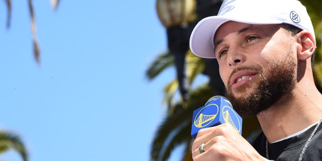 Stephen Curry of the Golden State Warriors speaks to the crowd during the 2022 NBA title parade June 20, 2022, at Chase Center in San Francisco.