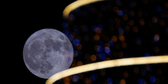 The full moon rises over Baghdad, Iraq, on Wednesday, July 13, 2022.