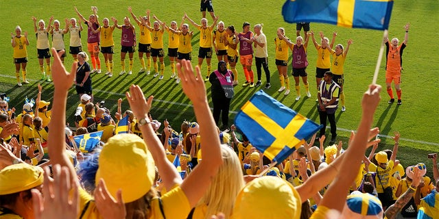 Sweden players celebrate with the fans at the end of the Women Euro 2022 group C soccer match between Sweden and Portugal at Leigh Sports Village, in Leigh, Manchester, England, Sunday, July 17, 2022. Sweden won 5-0 to advance to the quarterfinals. 