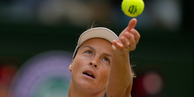 Tatjana Maria serves to Ons Jabeur in a women's singles semifinal match at Wimbledon, Thursday, July 7, 2022.